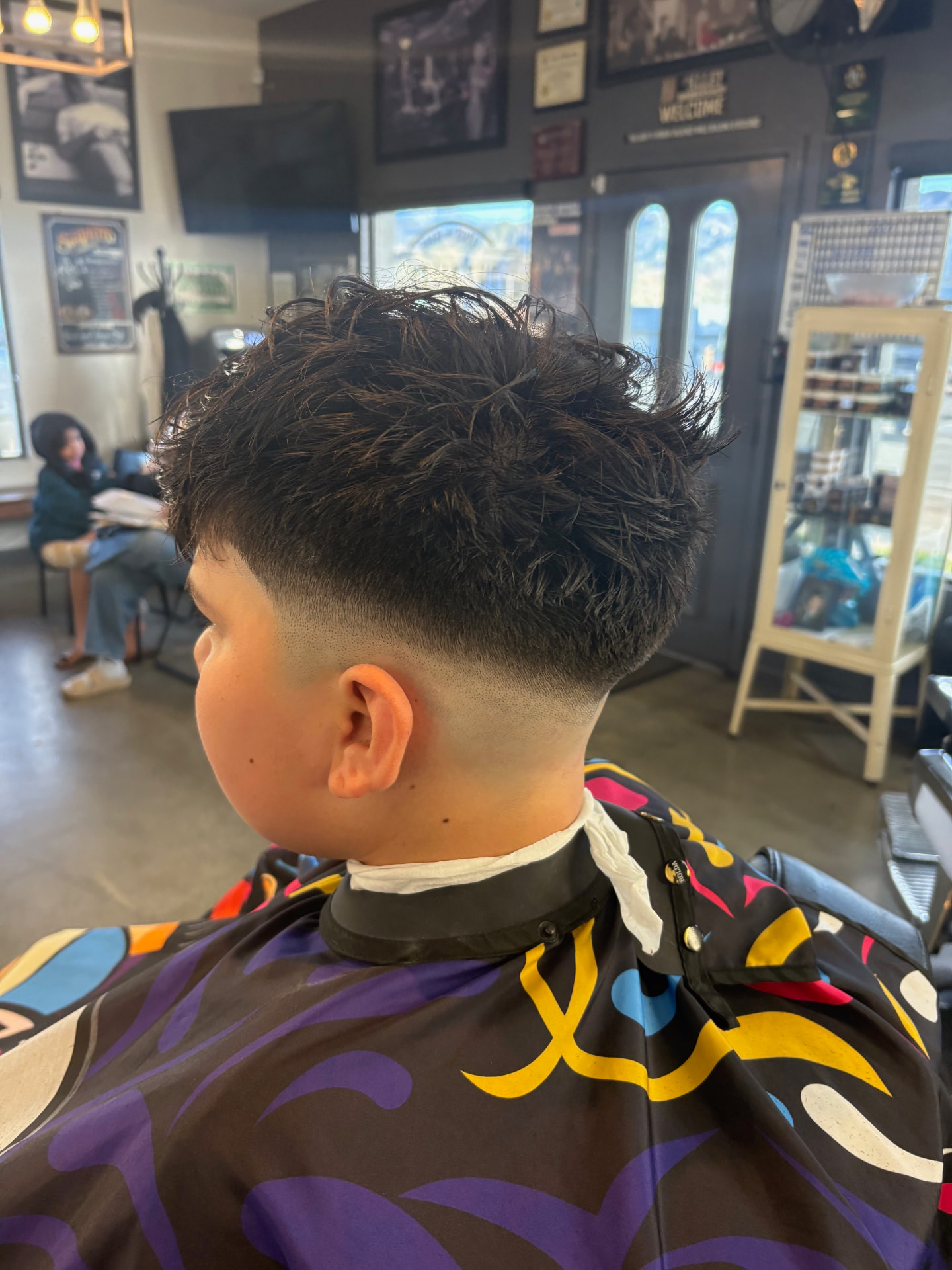 Textured haircut with a clean fade by Kai