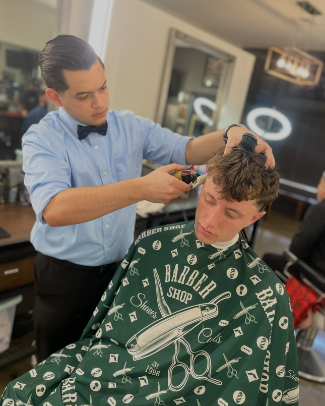 Daniel cutting a client's textured hairstyle at The Alley